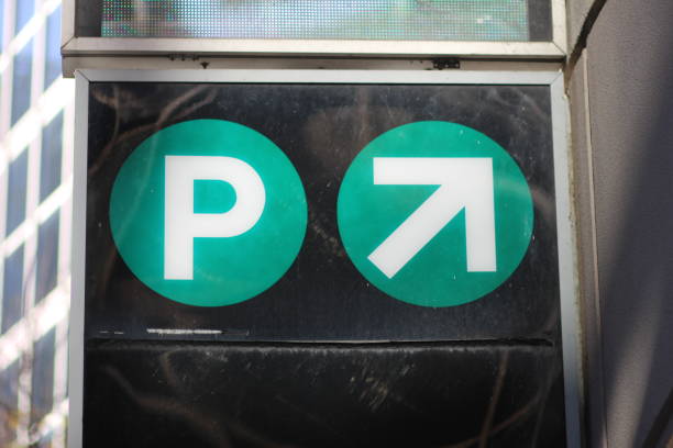 A parking sign with a upward arrow