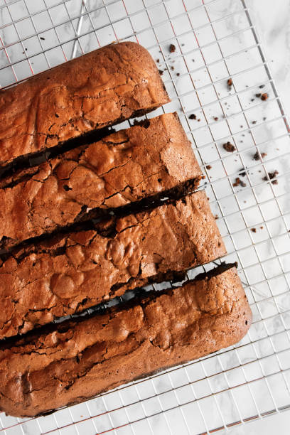 istock Baked brownies cooling on a kitchen counter on a wire rack 2156036850