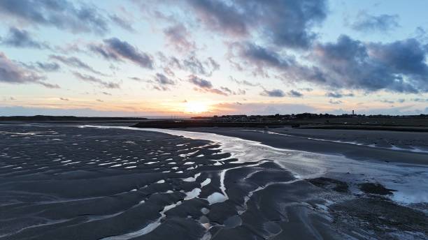istock Port-Bail-sur-Mer Harbor with sand dune in foreground with cloudy sky 2156037180