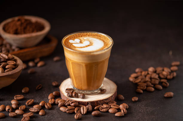 istock Cup of cappuccino with coffee beans on the table 2156037713