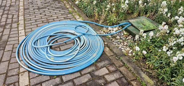 istock Hose connected to box in flower garden 2156038568