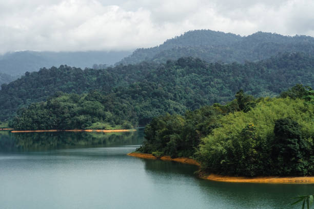 istock Kuala Kubu Bharu, Malaysia, features tropical trees and a green lake. 2156039228