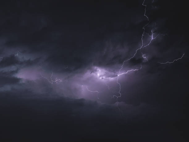 istock lightning strikes across a dark, cloudy night sky as it moves towards the camera 2156039638