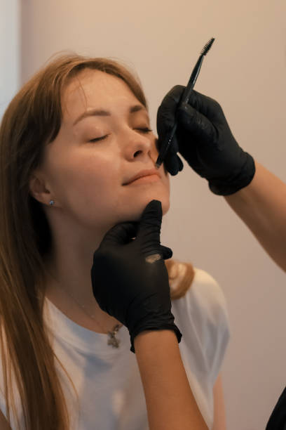 istock permanent makeup on lips in beautician salon. 2156040789