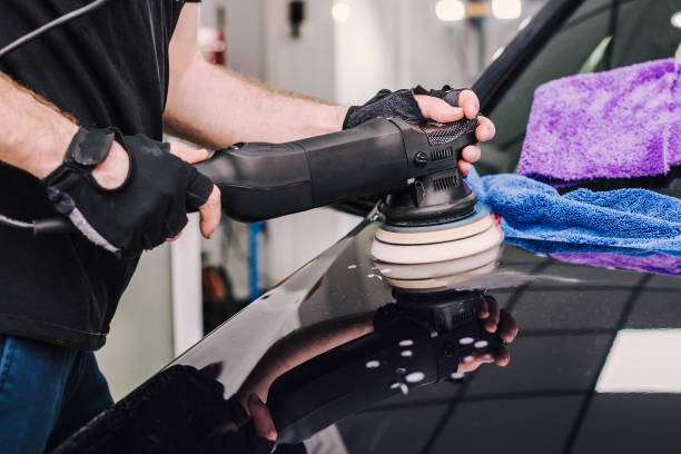 istock Man using a sander to polish a car's surface 2156041211