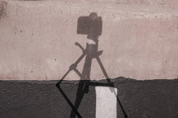 A silhouette of a camera on a tripod