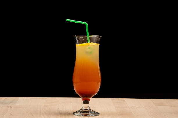 istock Refreshing orange beverage with a straw on a table against a dark backdrop 2156041534