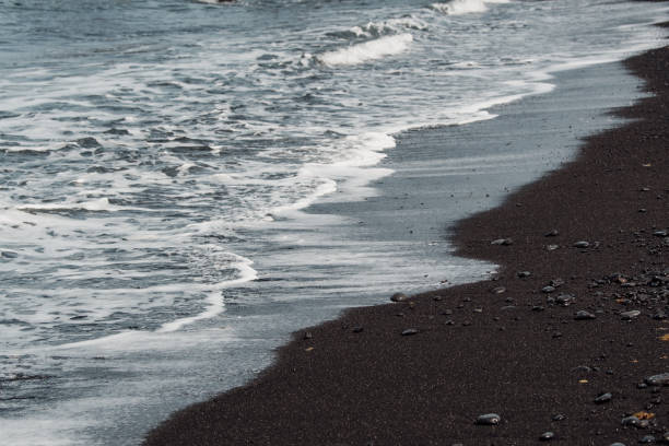 istock Detail of shallow waves on a black beach 2156042145