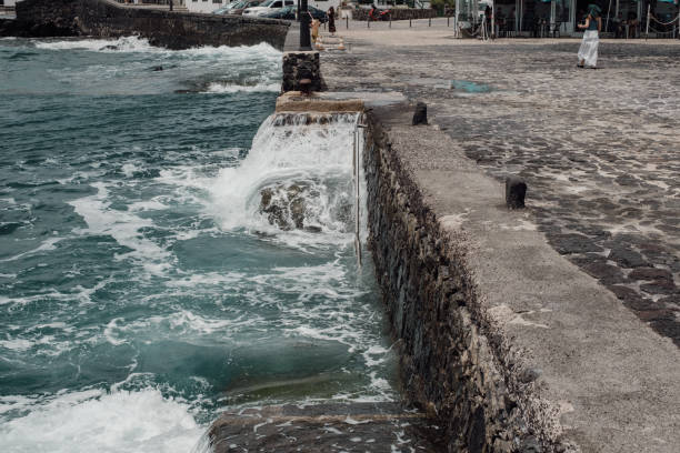 istock Waves wash over a staircase on the pier 2156042372