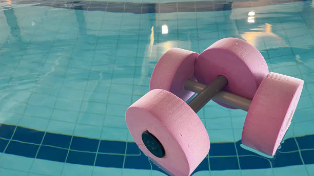 istock an empty swimming pool with Styrofoam exercise equipment floating in it. 2156042600
