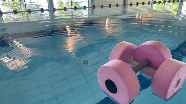 istock an empty swimming pool with Styrofoam exercise equipment floating in it. 2156042619