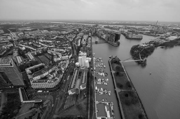 The Dusseldorf cityscape with bridge and river under cloudy skies, captured from above