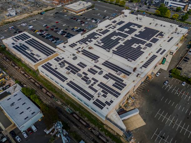 istock Aerial view over a large warehouse with many solar panels on the roof. 2156044794
