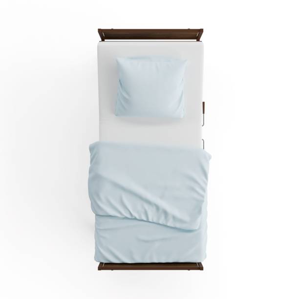 istock a white bed with blue sheets and pillows next to a pillow 2156049102