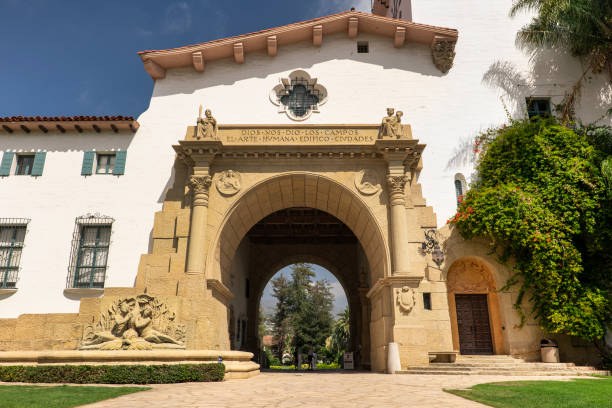 Framed by arches, columns, a Saturn-shaped art deco chandelier, and parallel lines of a red tiled floor is a Corridor to Knowledge as seen at California Institute of Technology in Pasadena, California.