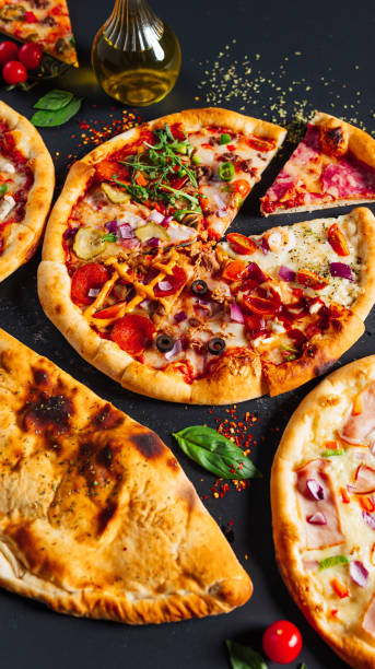 istock four small pizzas sitting on top of a table with cheese and olive 2156049933