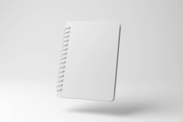 White spiral lined notebook floating in mid air on white background in monochrome and minimalism. Illustration of the concept of education, office stationary and note taking