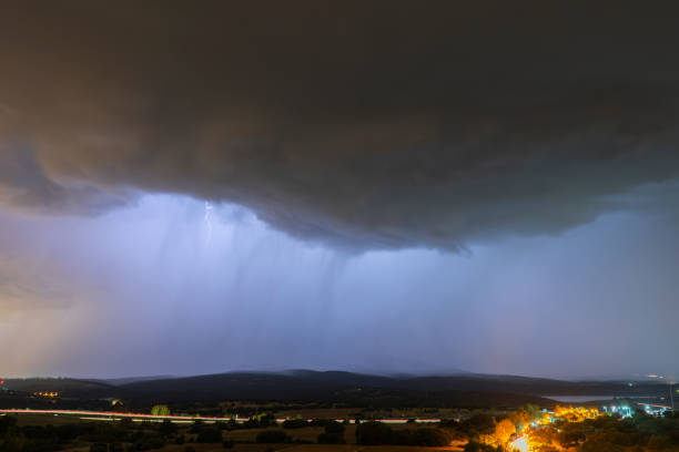 istock Stormy sky, black and dark. Lightning and thunder light up the night under heavy rain. Heavy thunder 2156053174