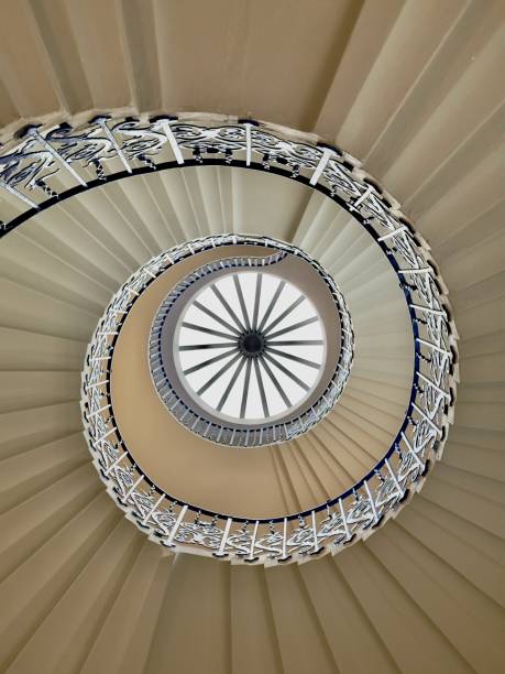 istock Spiral staircase with blue handrails and dome glass window 2156055789