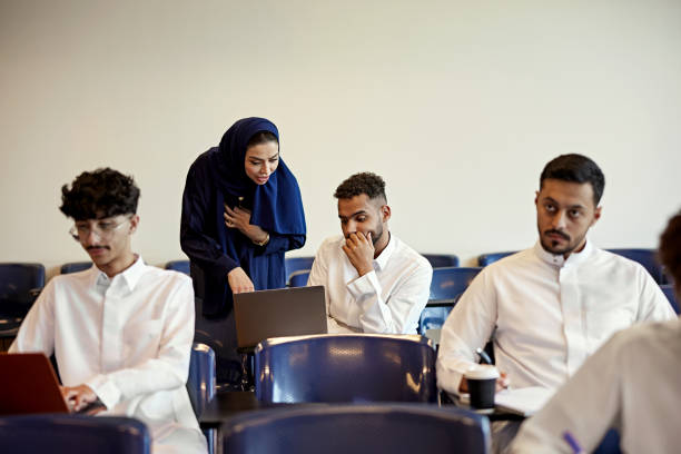 istock Teacher teaching male student in classroom 2156059066
