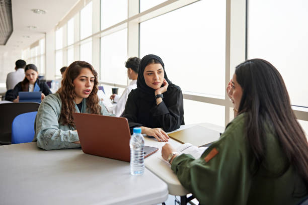istock Female students sitting and discussing in university 2156059185