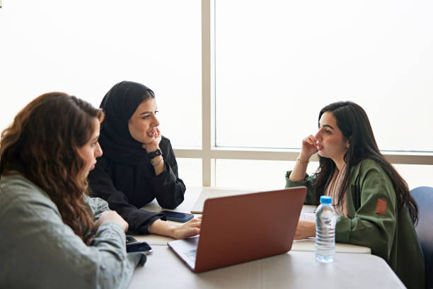 istock Female friends discussing with laptop in university 2156059186