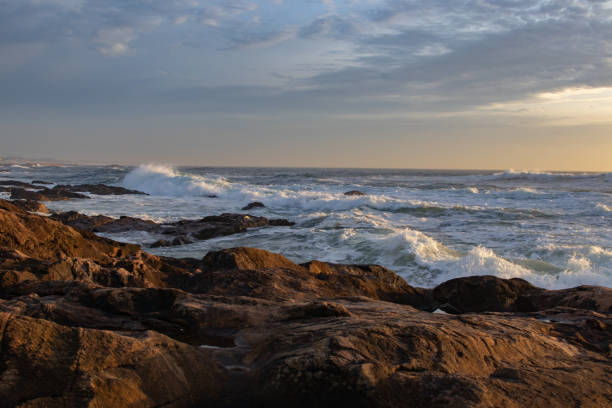 istock small waves breaking in the ocean next to rocks and waves 2156059406