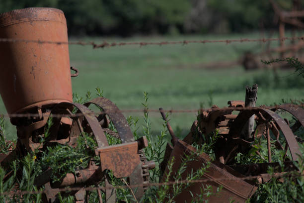 istock old rusted equipment that are near the ground with grass 2156059526