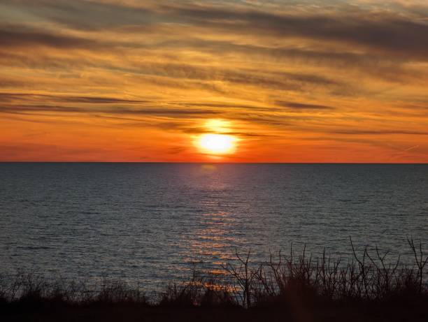 istock Sun setting over the cloudy ocean at sunrise 2156059635