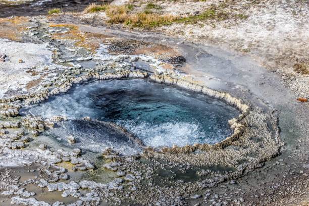 istock Hot spring in rocky surroundings under sunny skies 2156059878