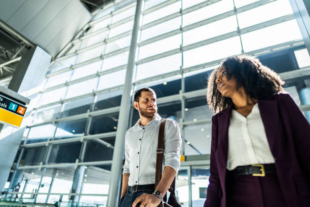 istock Coworkers talking while walking at the airport 2156060062
