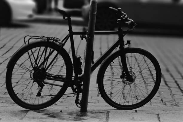 istock Monochrome image of a bicycle leaning against pole with missing tire 2156060367