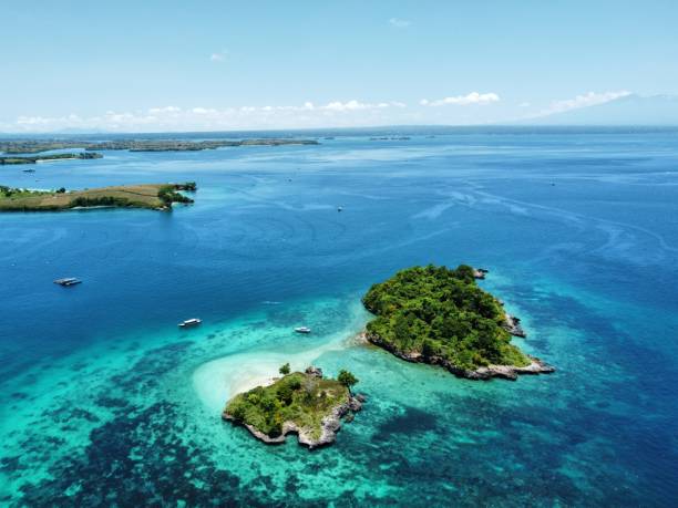 istock an island in the ocean with several small islands surrounded by water 2156060800