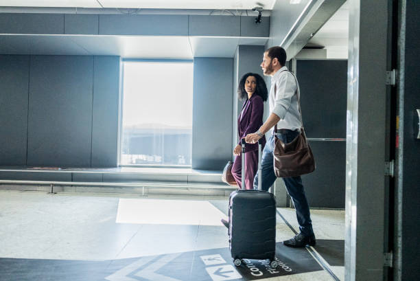 istock Coworkers talking while walking in the airport 2156060813