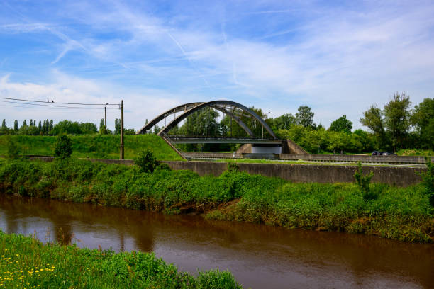 istock Partially submerged bridge surrounded by water and grass 2156062223