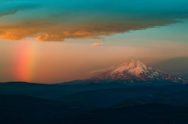 Rainbow over mountains with second rainbow in background