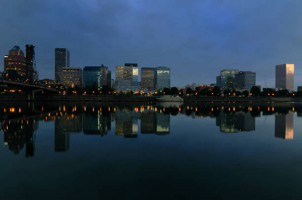 A City skyline and water reflections on a serene river surface