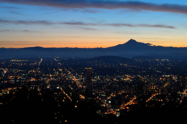 istock City lights shine brightly at night, viewed from a hillside 2156062344