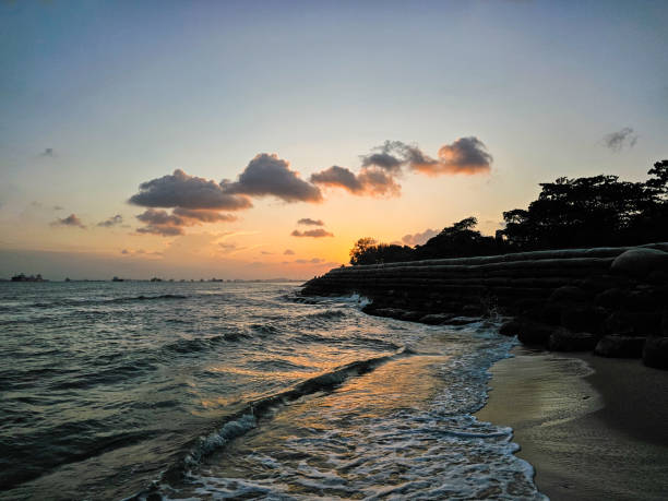 istock Sunset at beach with waves crashing on shore 2156062599