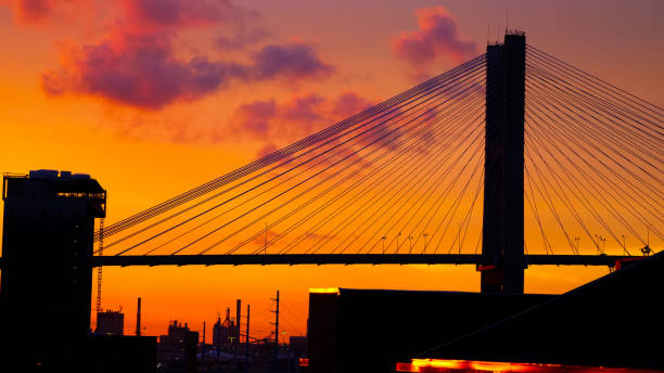 istock Sunset behind a bridge viewed from an island 2156062680