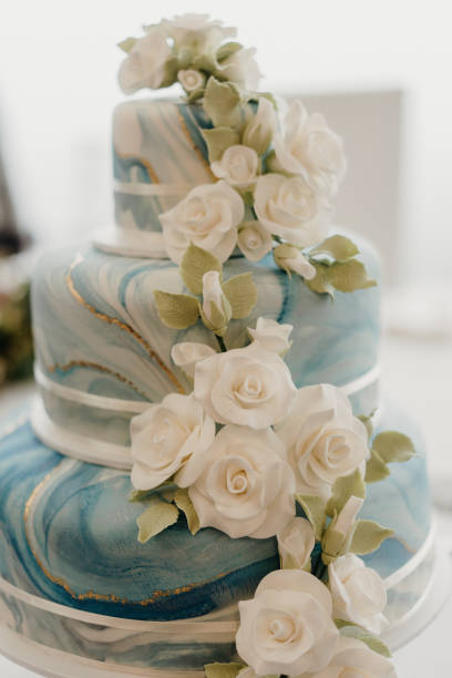 istock an artisticly decorated three tiered wedding cake with flowers on top 2156062773