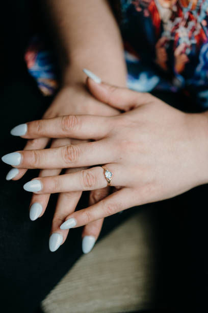 istock a woman with white nails and engagement ring on her left hand 2156062845
