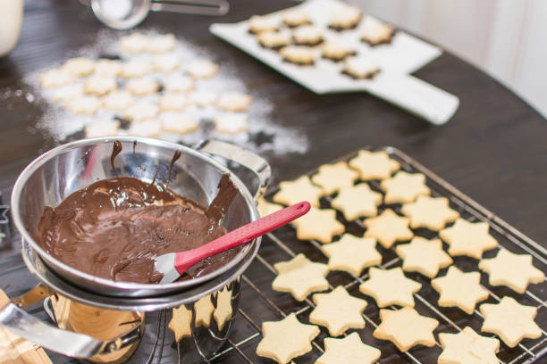 istock Christmas cookies in star shape will be covered with chocolate. 2156063178