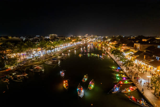 istock River winding through an urban busy setting aglow with nighttime lights 2156063467