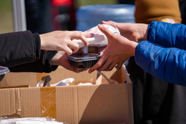 Person sharing their food with another at an event