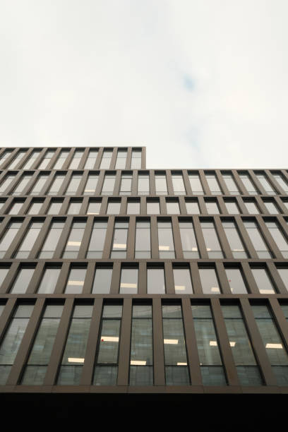 istock a tall glass building is illuminated by the sun as seen from below 2156064741