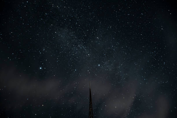 Astrophotography. Starry sky long exposure. Night, dusk. What appears to be a Starlink train.