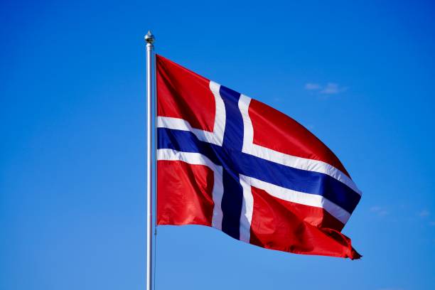 istock Norwegian flag flutters on a sunny day from a flagpole 2156066421