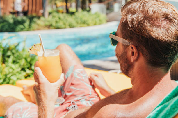istock Man Lounging by the Pool with a Drink 2156066820