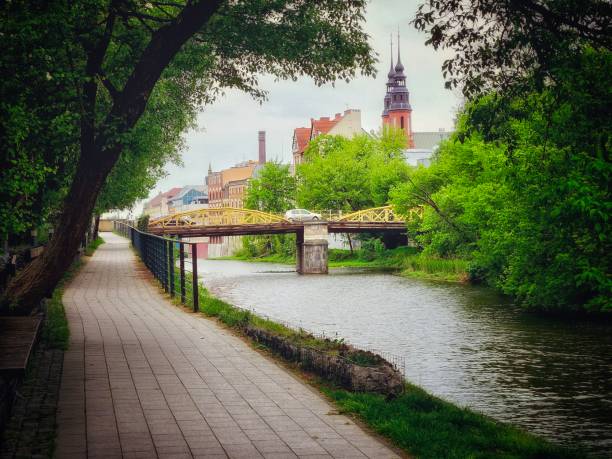 A path over canal in Opole with cathedral in background